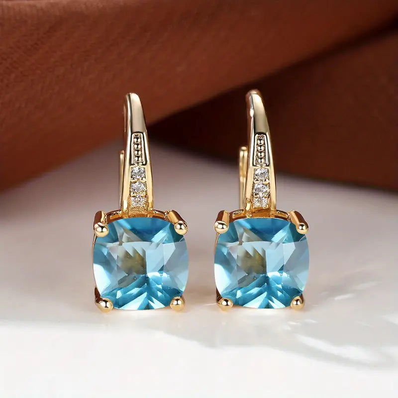 Claudine – Golden Hoop Earrings with Enigmatic Sapphire