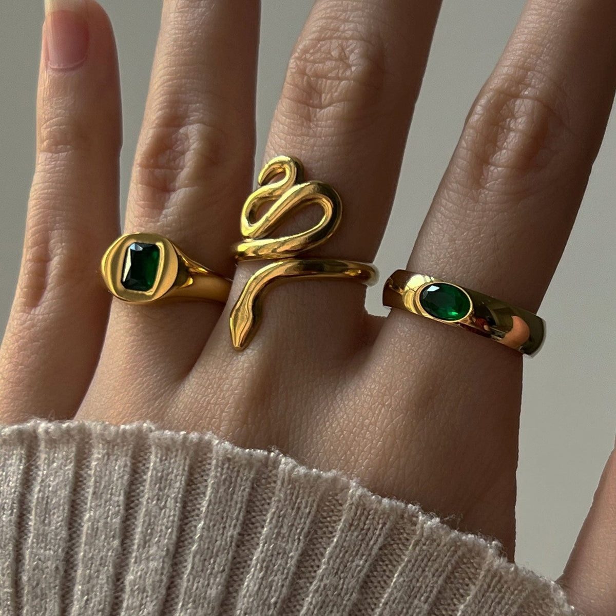 Gold ring featuring a sparkling green gemstone