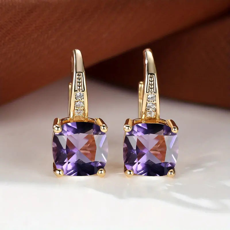 Claudine – Golden Hoop Earrings with Enigmatic Sapphire