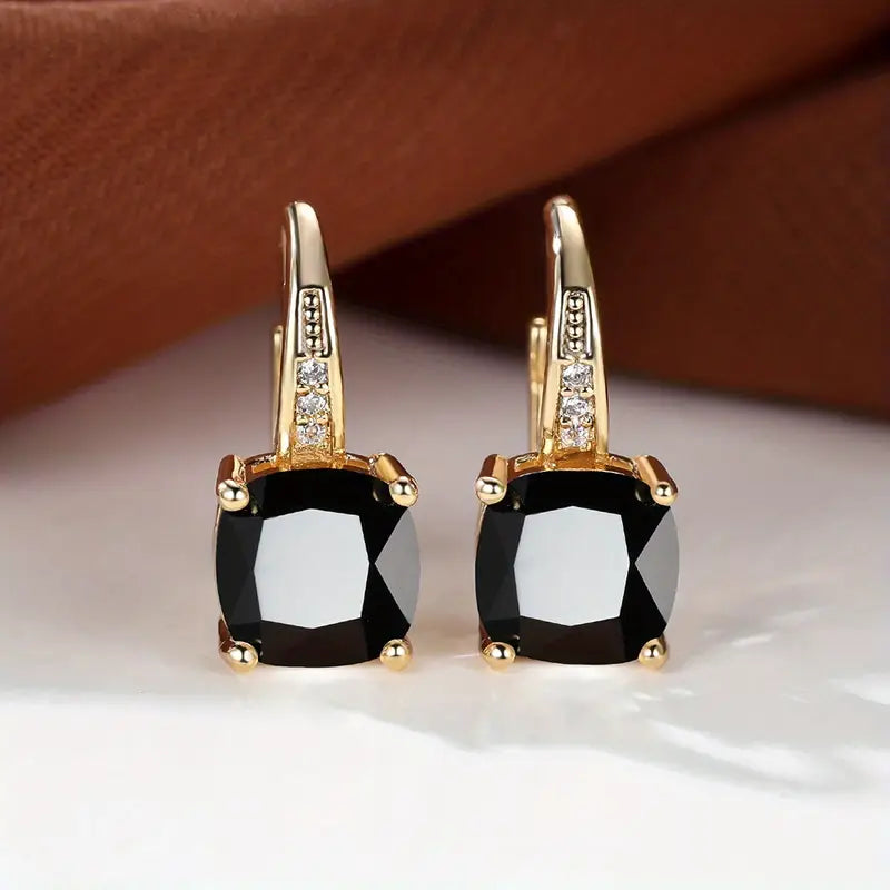 Claudine – Golden Hoop Earrings with Enigmatic Sapphire
