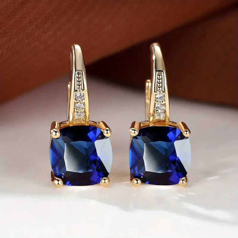 Claudine – Golden Hoop Earrings with Enigmatic Sapphire