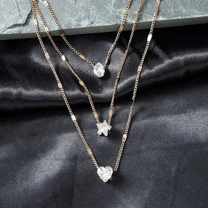 Sally – Gold chain featuring three zirconia pendants