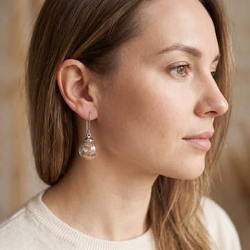 Liora – Silver earrings featuring a dandelion design