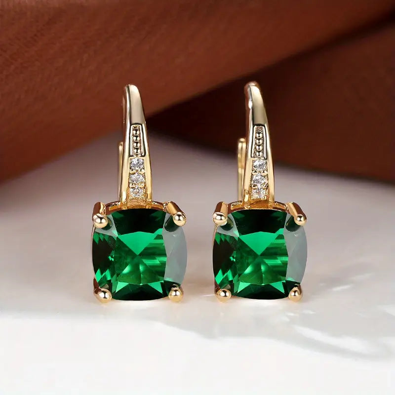 Claudine – Golden Hoop Earrings with Enigmatic Sapphire