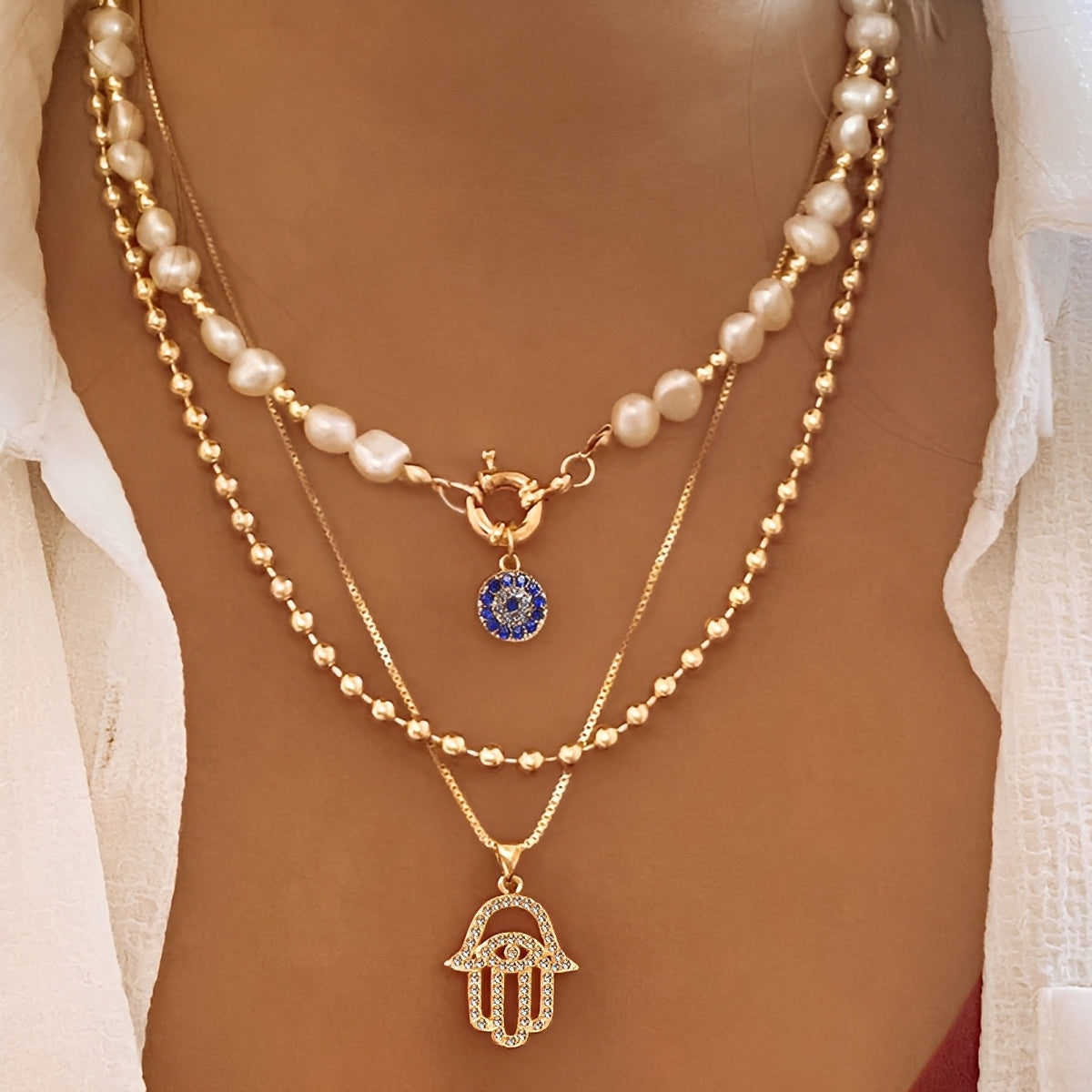 Nadia – Multi-Strand Pearl Necklace with Hamsa Hand