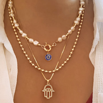 Nadia – Multi-Strand Pearl Necklace with Hamsa Hand