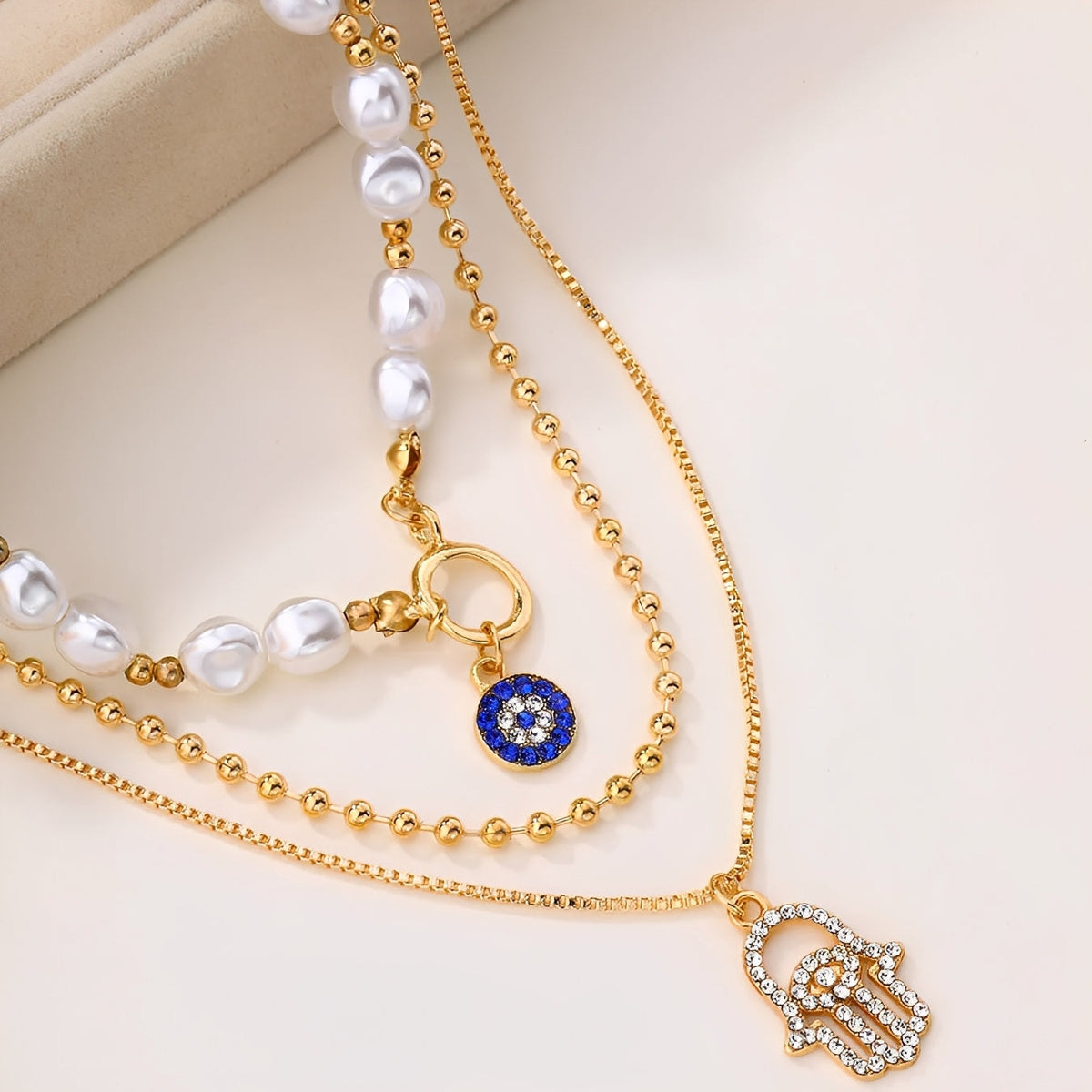 Nadia – Multi-Strand Pearl Necklace with Hamsa Hand